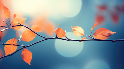 Enchanting Leaves: Closeup of Vibrant Colorful Leaves on Branch with Soft Blue and Orange Hues