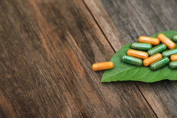 Green herbal capsules from herb for healthy eating in daily life with herb leaf
