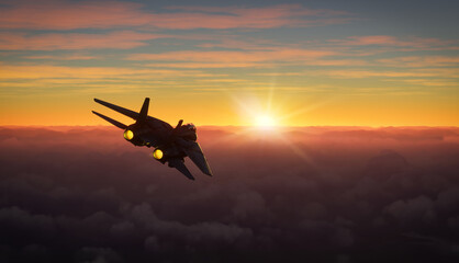 Silhouette of militar aircraft flying over the clouds in amazing sunset