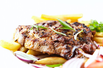 Grilled Steak with french fries and fresh tomatoes. White wooden background.	