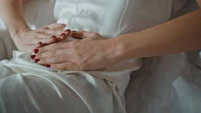 Hands touching pain stomach closeup. Sick woman suffering severe ache at home