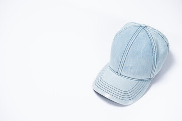 Blue denim cap close-up on white background, copy space for text.