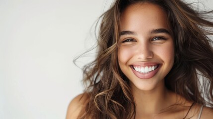 Naklejka premium Portrait of a beautiful young latin model woman smiling on a white background