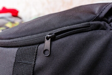 Close-up of travel backpack with zipper, preparing for summer vacation.