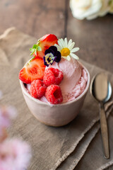 Homemade Strawberry ice cream, in a ceramic bowl on the table. Healthy summer dessert. Selective Focus
