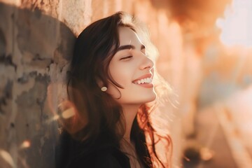 Smiling Woman Leaning Against a Wall with Golden Sunlight