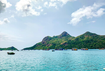 Obraz premium Beautiful Landscape With Coastal Mountain And Fishing Boats On The Sea Of Con Dao Island, Vietnam. Con Dao Island Is An Ideal Off The Beaten Path Beach Destination In The South Of Vietnam.