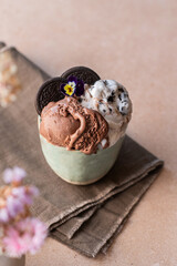 Homemade chocolate and Oreo ice cream, in a ceramic bowl on the table. Healthy summer dessert. Selective Focus
