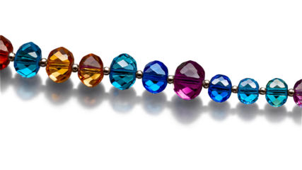 A collection of smooth faceted crystal beads in varying sizes catching and refracting light to create a dazzling effect.