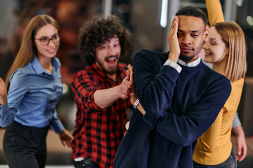 A group of young business people have fun playing interesting games while taking a break from work in a modern office. Selective focus 