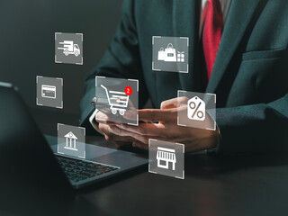 Businessman uses phone and laptop with virtual reality screen Explore online shopping services that...