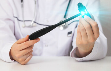 A neurological hammer is in the hands of a neurologist. Concept for treating the nervous system,...