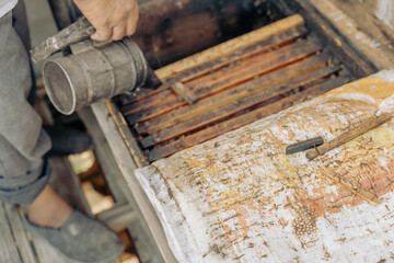 A person is pouring something into a container