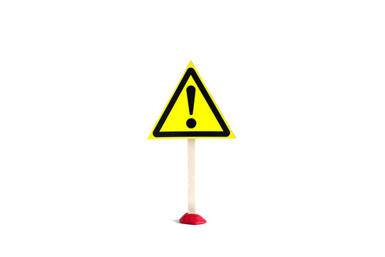 Warning sign exclamation mark in a yellow triangle on a stick on a white background, isolate