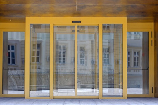 Automatic Sliding Doors Golden Entrance to Modern Office Building