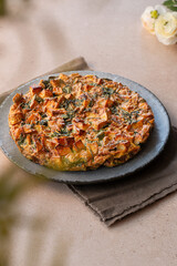 Potato and spinach tortilla on the table. Potato frittata.