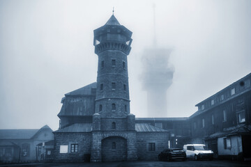 Lookout tower and blurry telecommunication tower on Klinovec hill in Ore mountain.