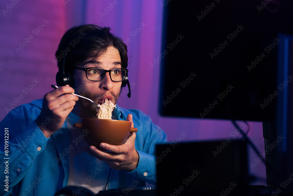 Poster a man is shown in a dark room sitting in front of a computer screen while wearing a headset. he is h