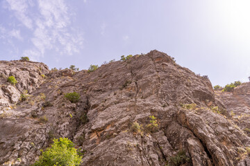 A rocky mountain with a clear blue sky