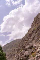 A mountain range with a cloudy sky in the background