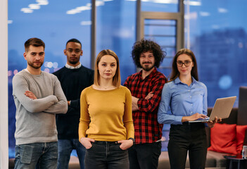 Portrait of successful creative business team looking at camera and smiling. Diverse business people standing together at startup. Selective focus 