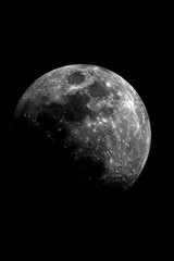 Fototapeta premium A black-and-white image of the moon against the night sky, with a plane traversing its path