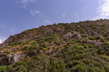 A mountain with a blue sky in the background