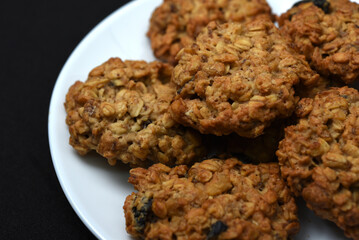 Sweet oatmeal cookies with filling on a white plate. A sweet breakfast.