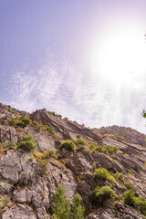 A mountain with a clear blue sky and a sun shining on it