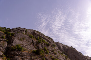 A mountain with a cloudy sky in the background