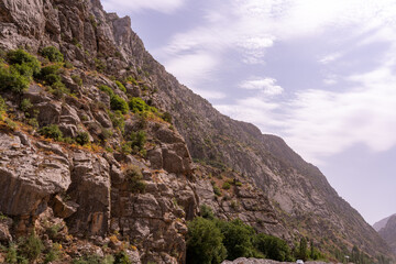 A mountain range with a cloudy sky in the background