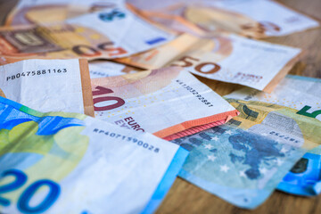 Banknotes of different denominations of euro on the desk