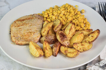 seasoned boneless pork chop  with potato wedges