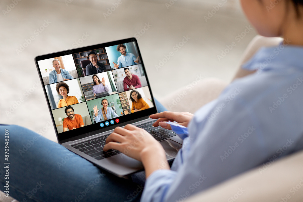Poster the image shows a woman sitting on a couch, participating in a video conference on a laptop computer
