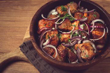 fried meat, pork kebab, ketsi in a clay pan, with red onions and herbs, homemade, no people,