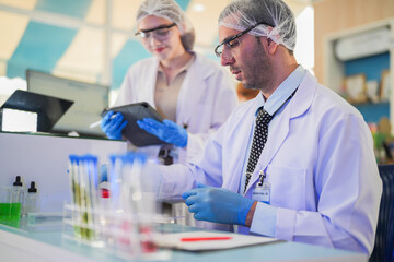 esteemed scientists elegantly dressed in lab coats are meticulously testing chemicals innovative...