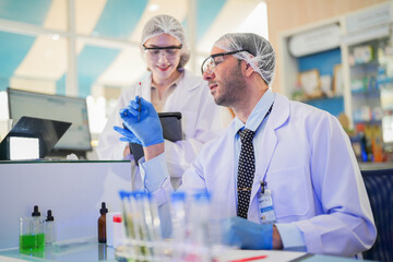 esteemed scientists elegantly dressed in lab coats are meticulously testing chemicals innovative...