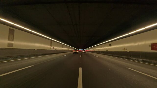 Time Lapse: Car point of view POV on a sunny day driving through the four-lane tunnel M30 from Portugal Avenue to Spain Square with buses, taxis and cars circulating. POV driving a car in Madrid