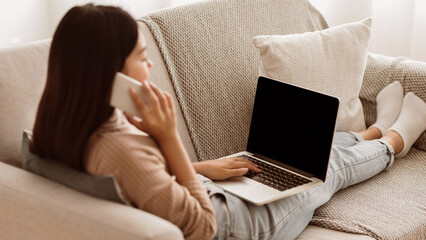 Multitasking. Student Girl Working on Laptop and Talking on Phone at Home, Copy Space