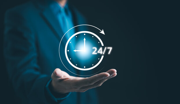 Nonstop service 24 hr concept. businessman hand holding virtual 24-7 with clock on hand for worldwide nonstop and full-time available contact of service concept. Assistance customer services,