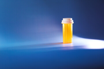 empty medicine bottle with blue background 