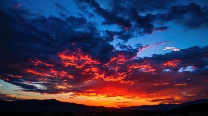Vibrant sunset sky with dramatic clouds over mountain landscape