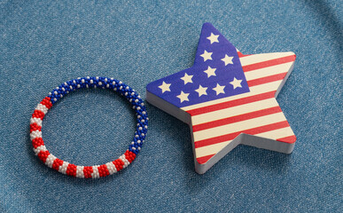 Obraz premium USA patriotic flag on a star with bracelet on blue background