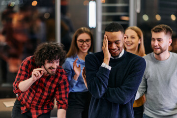 A group of young business people have fun playing interesting games while taking a break from work in a modern office. Selective focus 