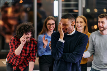 A group of young business people have fun playing interesting games while taking a break from work in a modern office. Selective focus 