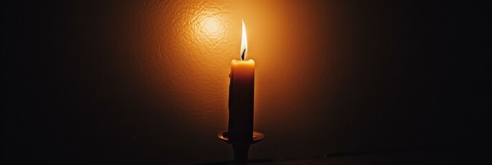 A single candle burning in the dark. AI.