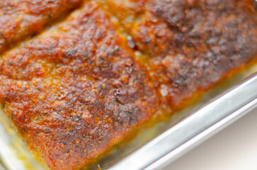 A piece of meat is cooked and has a crispy crust