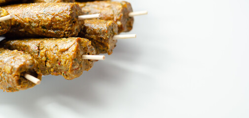 A bunch of skewers with meat on them