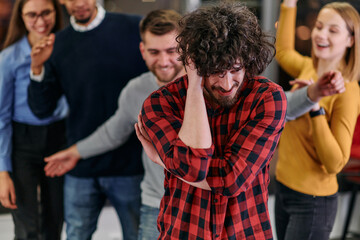 A group of young business people have fun playing interesting games while taking a break from work in a modern office. Selective focus 
