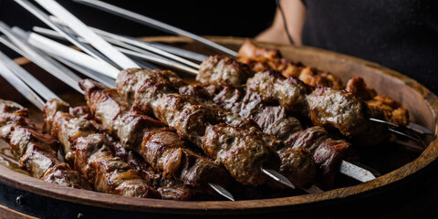 Waiter holding  a big plate with shashlik. BBQ